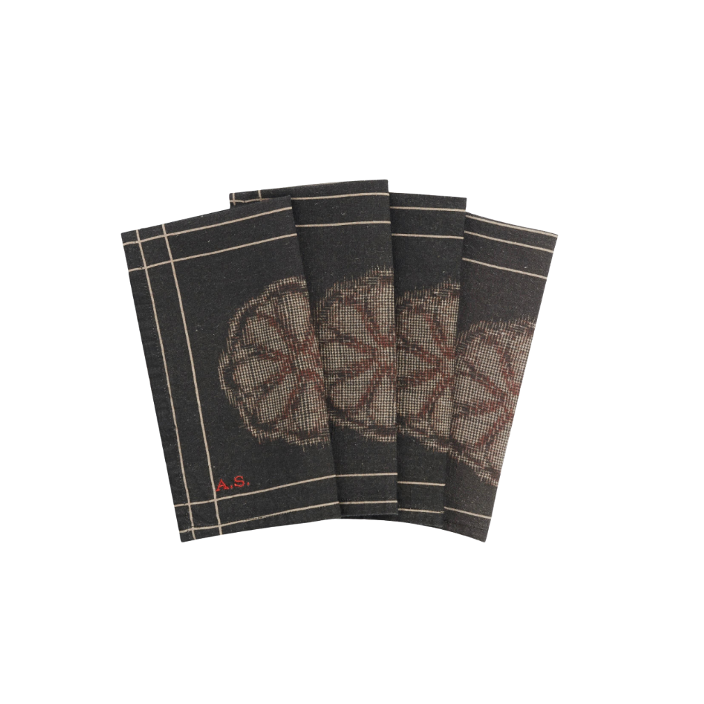 Set of four black napkins with floral pattern and striped border