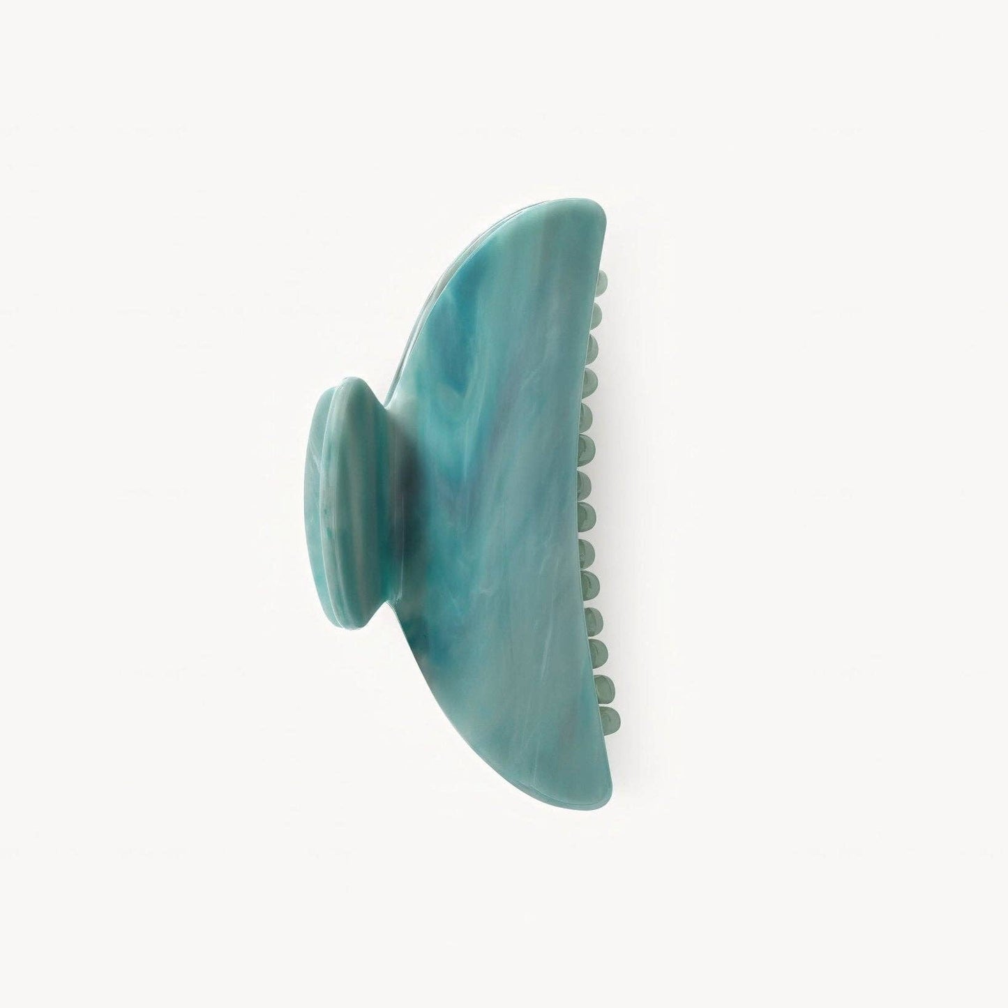 Teal hair clip on a white background