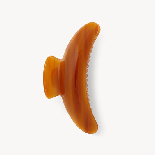 Orange hair clip on a white background