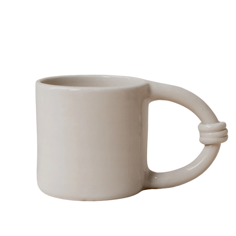 Beige ceramic mug with a unique handle design 