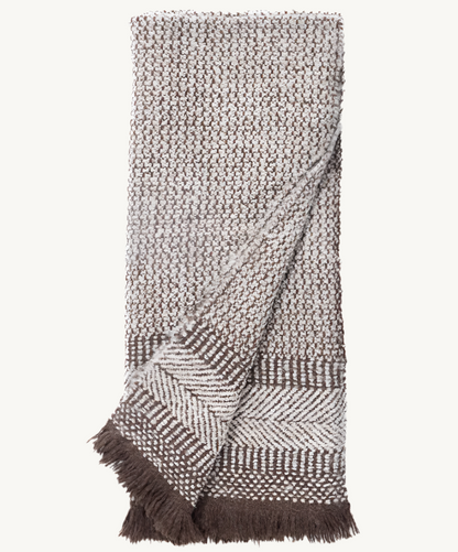 Chambi Saddle Alpaca Throw Blanket in warm saddle brown with soft brushed texture and fringe edges, perfect for layering on sofas or beds.