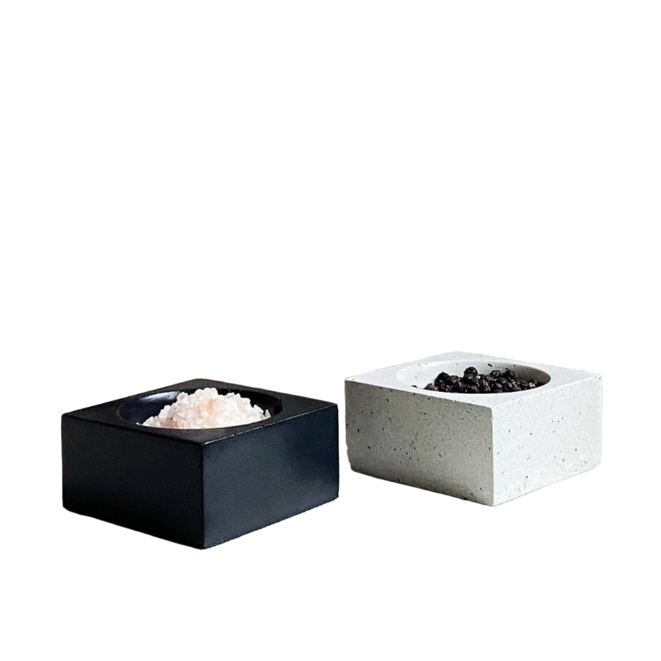 Square salt and pepper hand displays with semi circle holding spaces for spice.