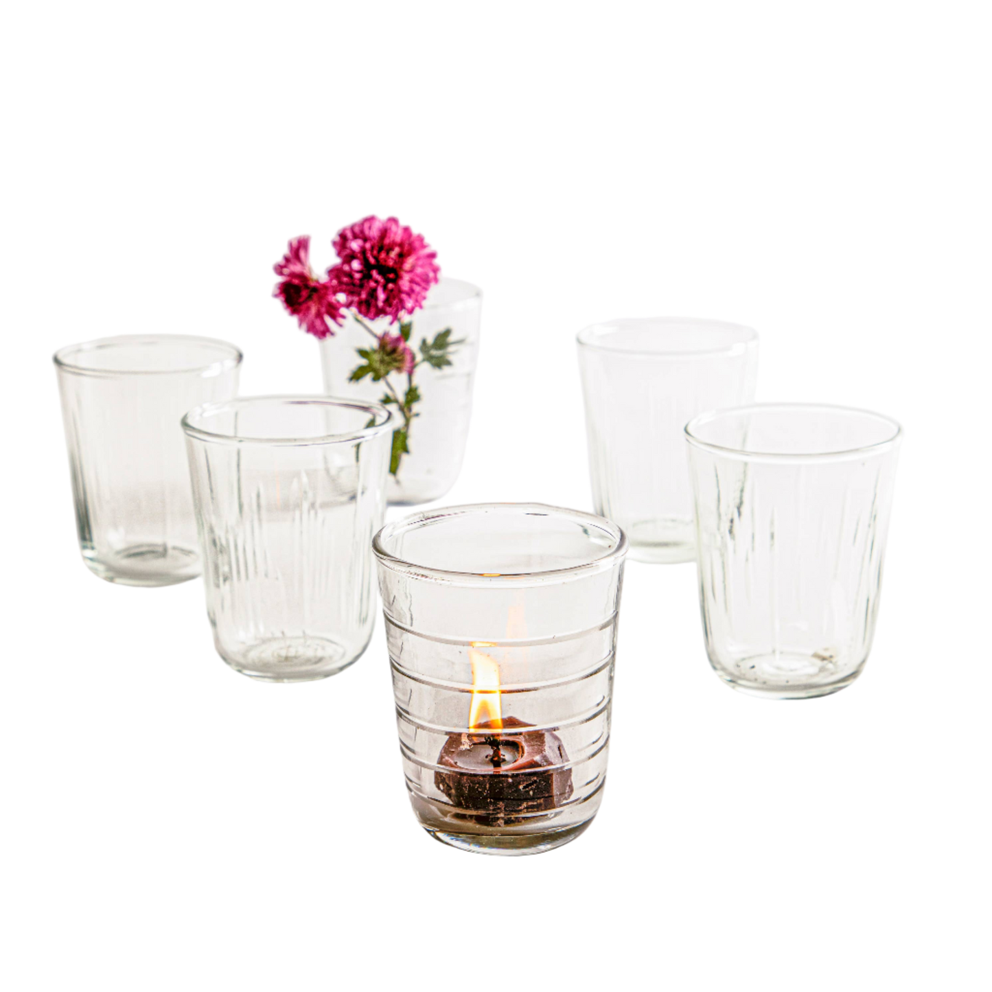 Short, clear glass tumblers with textured details on the sides for drinking or displaying