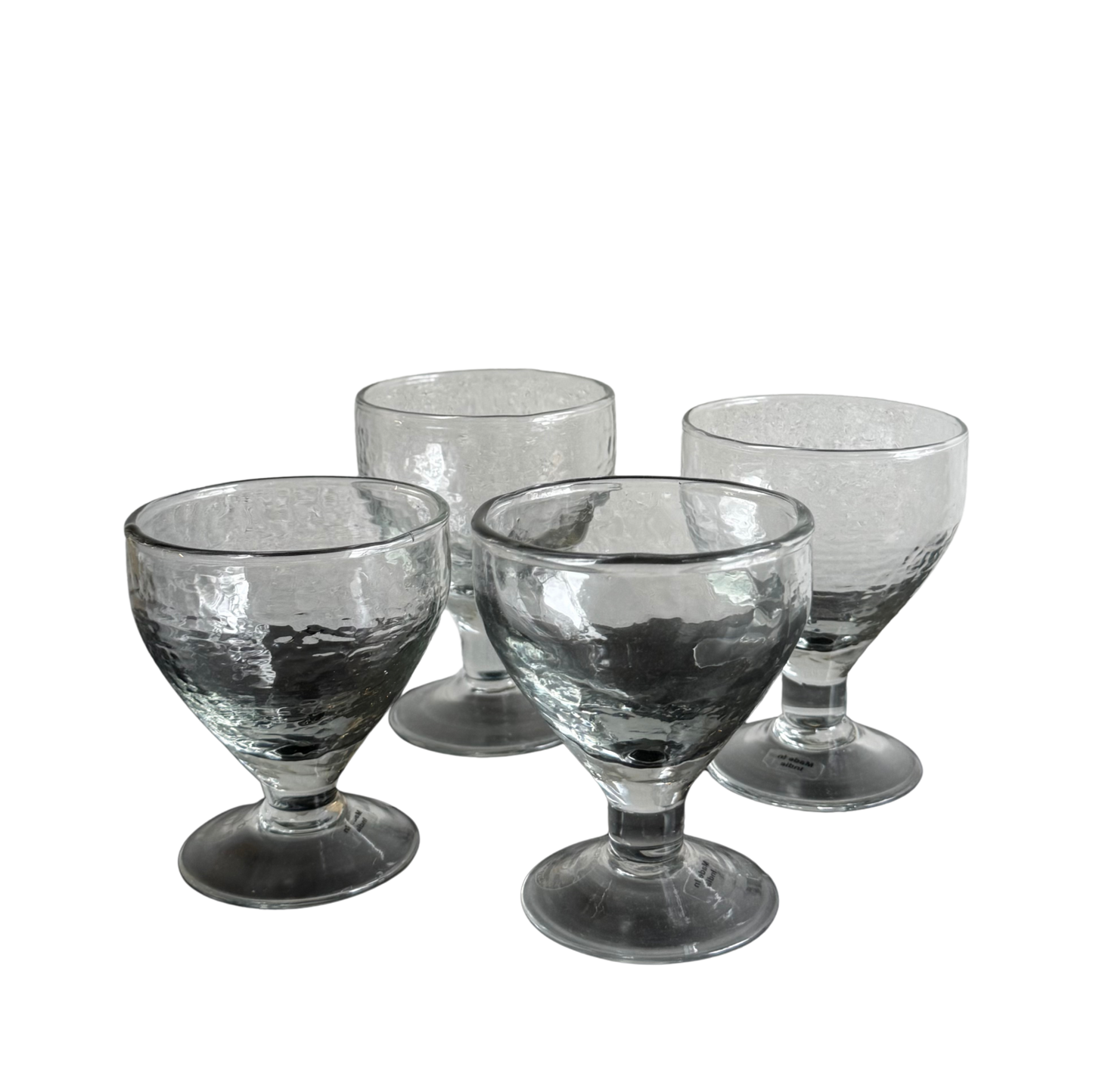 Set of four glasses with pebbeled texture and wide foot