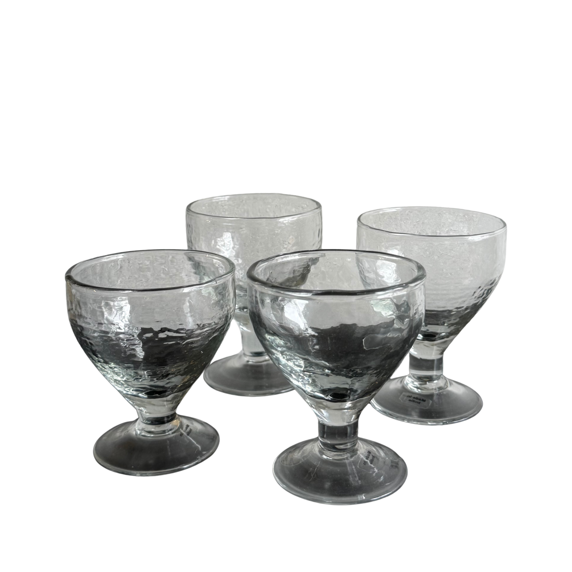 Set of four glasses with pebbeled texture and wide foot