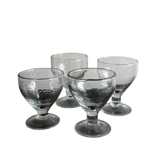Set of four glasses with pebbeled texture and wide foot