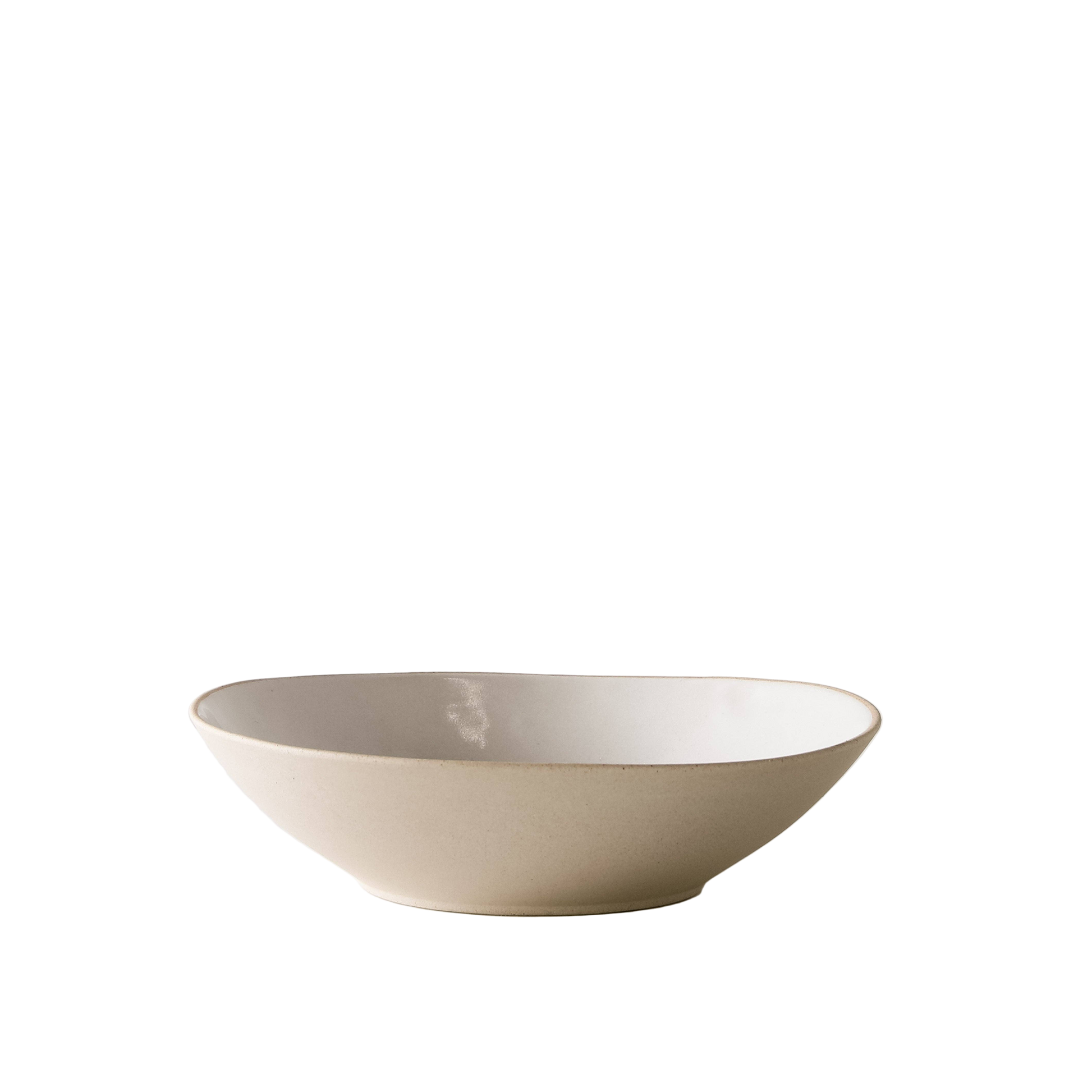 Shallow Serving Bowl is a beige ceramic bowl on a white background