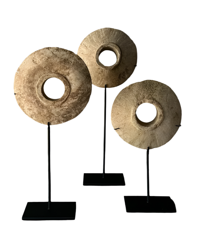 Small antique millstone mounted on base for rustic home décor