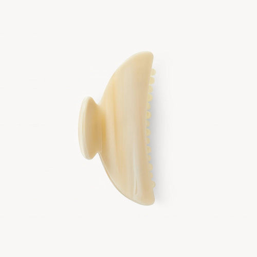 Beige hairbrush on a white background