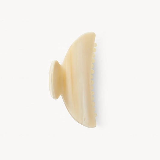 Beige hairbrush on a white background