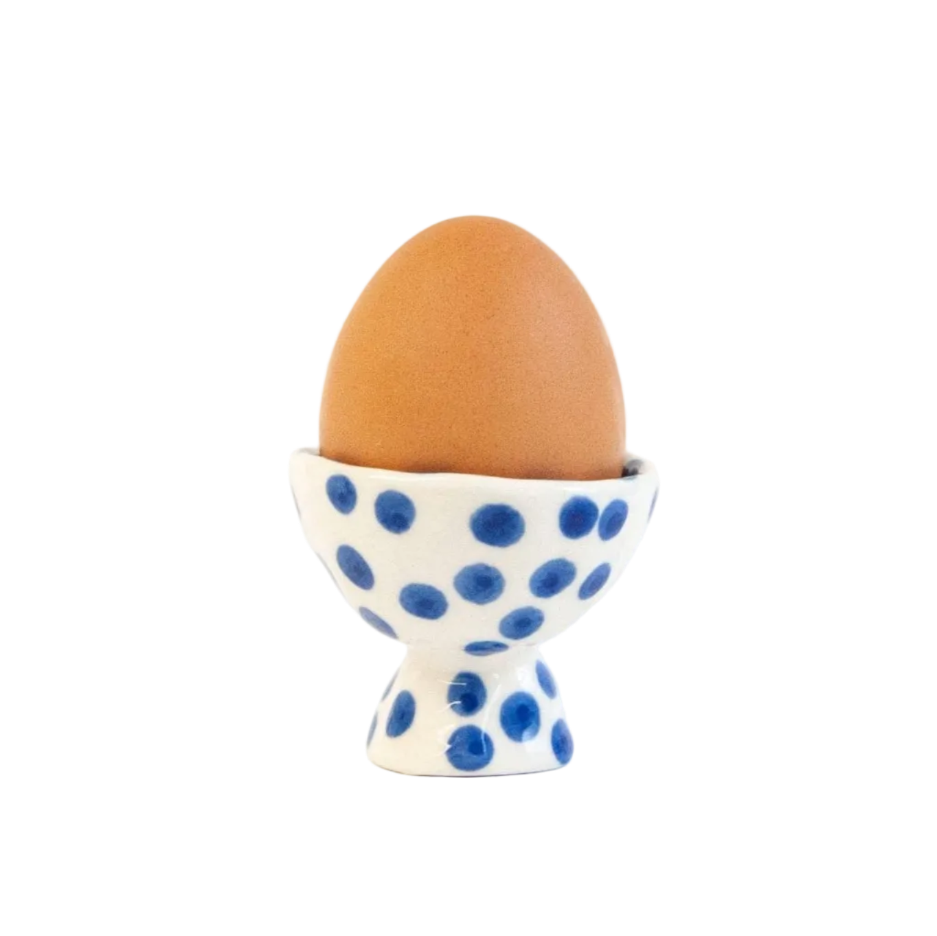 blue polka dot ceramic egg cup displayed with egg 