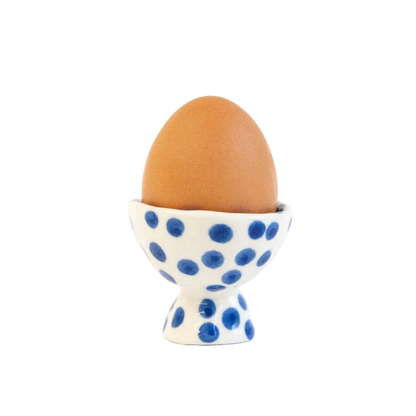 blue polka dot ceramic egg cup displayed with egg 