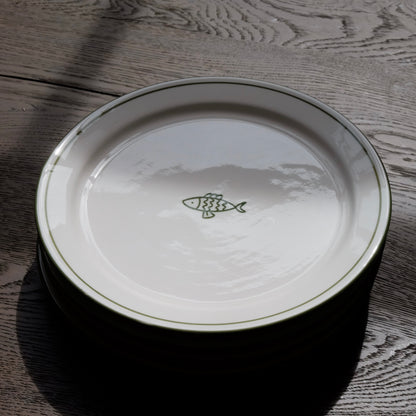 white ceramic dessert plate with green fish and trim detail