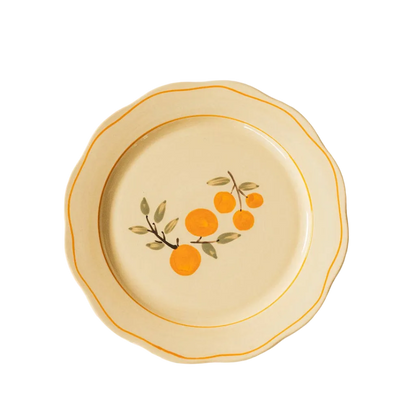 ivory ceramic dinner plate with citrus and orange trime detail 