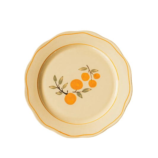 ivory ceramic dinner plate with citrus and orange trime detail 