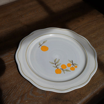 blue gray ceramic dinner plate with citrus and green trim detail