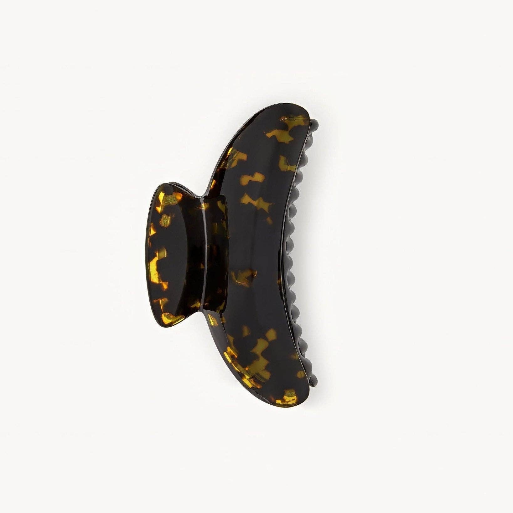 Tortoiseshell patterned hair clip on a white background