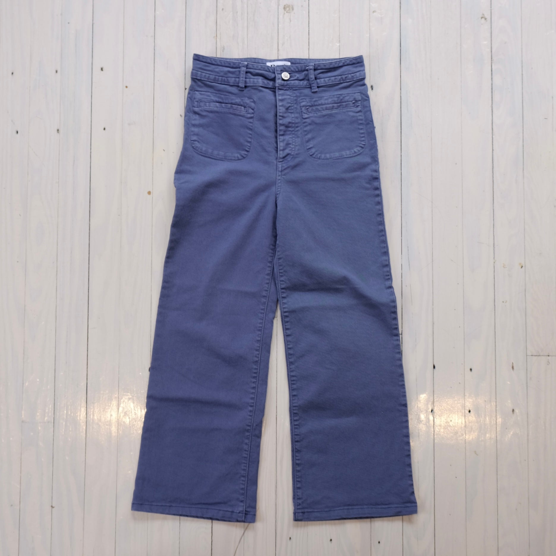 Blue pants on a light wooden floor