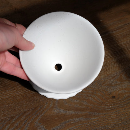 top view of white ceramic pour over coffee dripper with scalloped base 